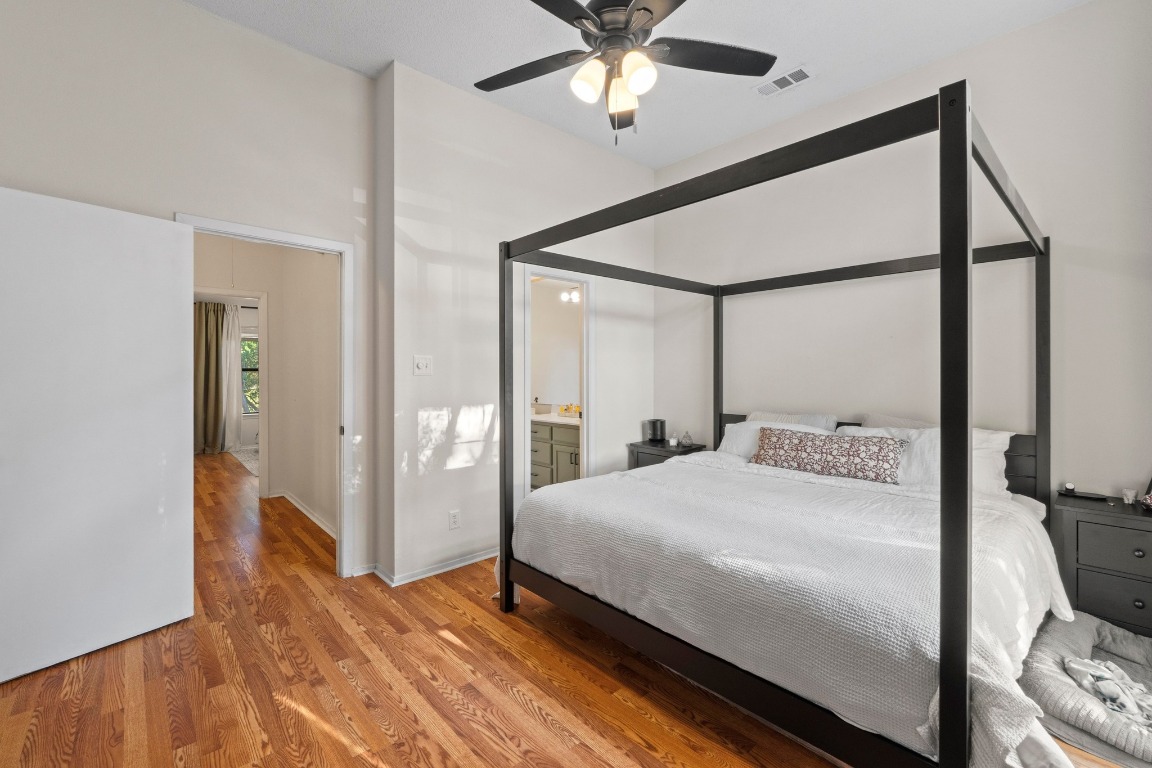 3801 Menchaca Road, Unit 5 Austin, TX 78704 - Photo 20 of 40 a bedroom with a large bed and a chandelier