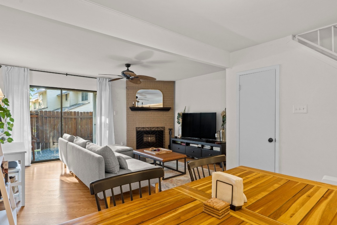 3801 Menchaca Road, Unit 5 Austin, TX 78704 - Photo 6 of 40 a living room with furniture a fireplace and a flat screen tv