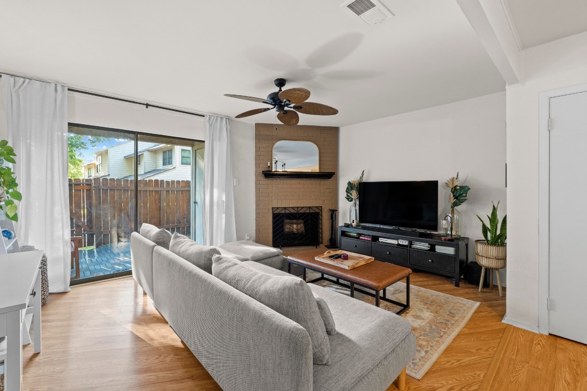 3801 Menchaca Road, Unit 5 Austin, TX 78704 - Photo 7 of 40 a living room with furniture a fireplace and a flat screen tv