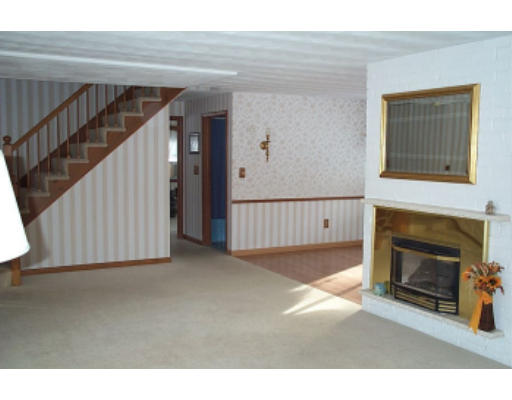 4 Judith Road Chelmsford, MA 01824 - Photo 3 of 6 a view of a livingroom with an empty space and a fireplace