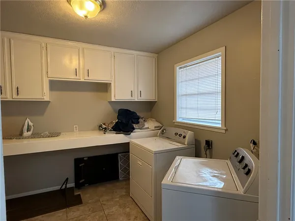 a room with a window and washer dryer