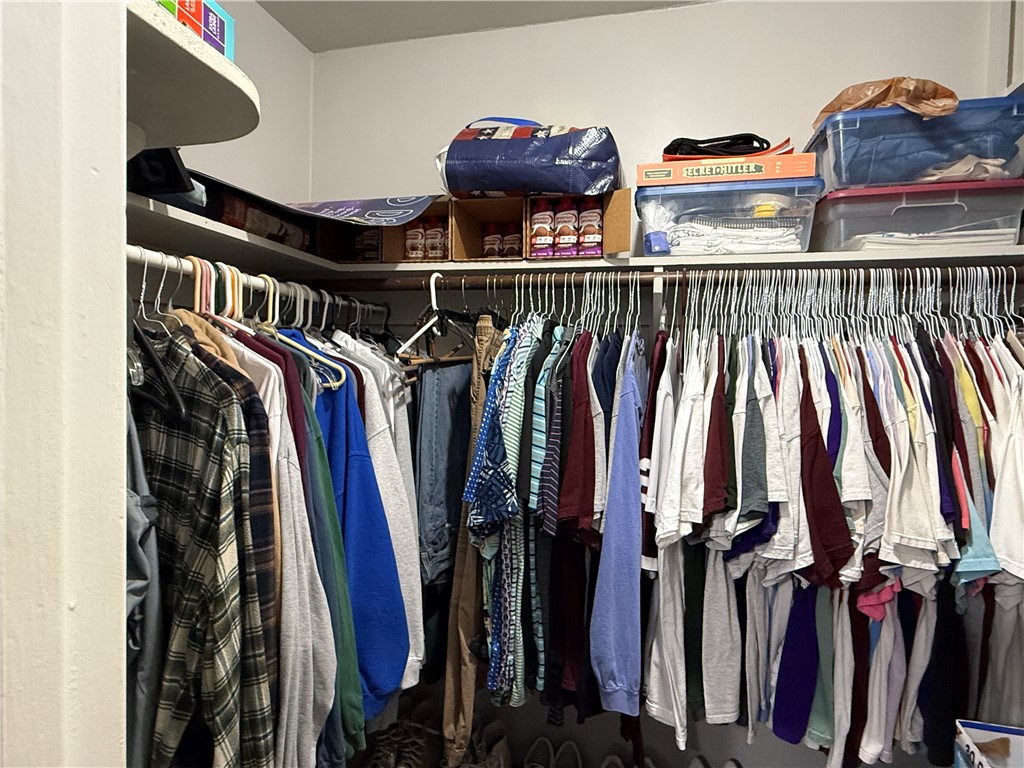 1213 Ridgefield Circle South College Station, TX 77840 - Photo 18 of 25 a view of walk in closet with clothes and shoes
