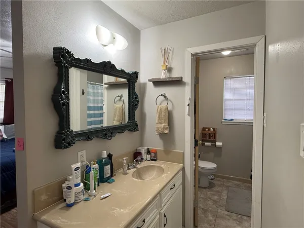 a bathroom with a sink vanity and a mirror