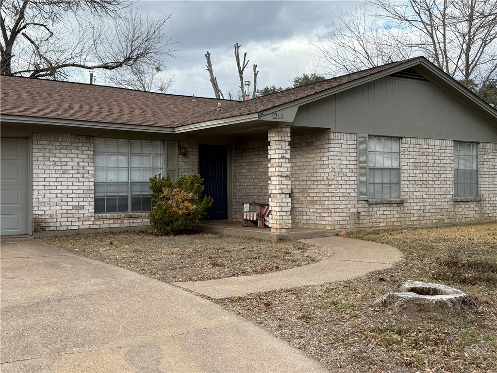 1213 Ridgefield Circle South College Station, TX 77840 - Photo 2 of 25 a front view of a house with a yard and garage