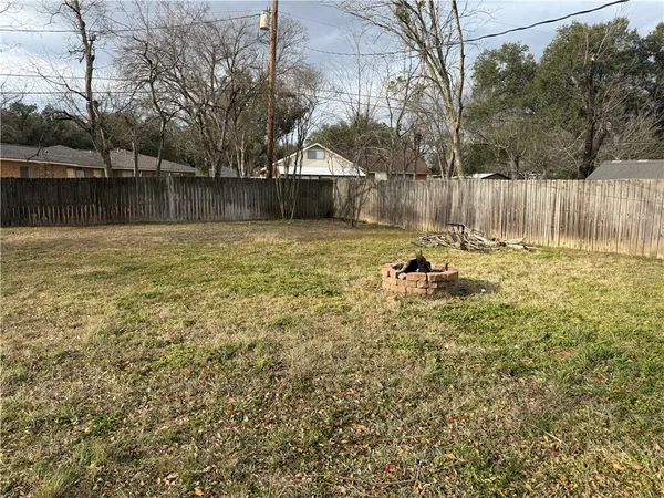 a backyard of a house with table and chairs