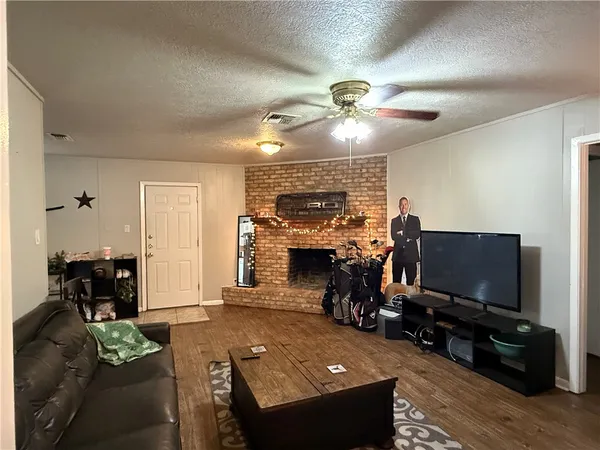 a living room with furniture a fireplace and a flat screen tv