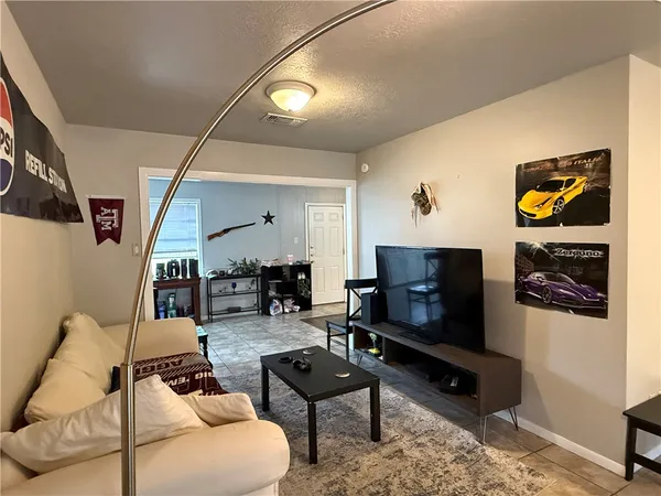 a living room with furniture and a flat screen tv