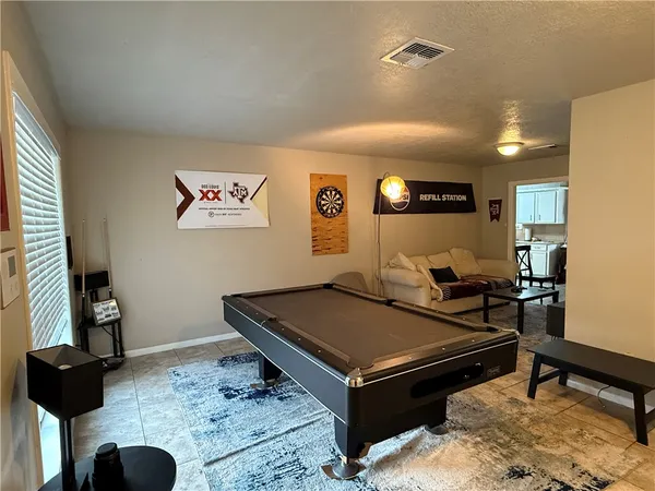 a living room with furniture and a rug