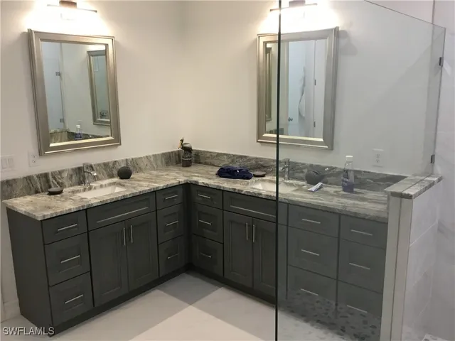 a bathroom with a double vanity sink and a mirror
