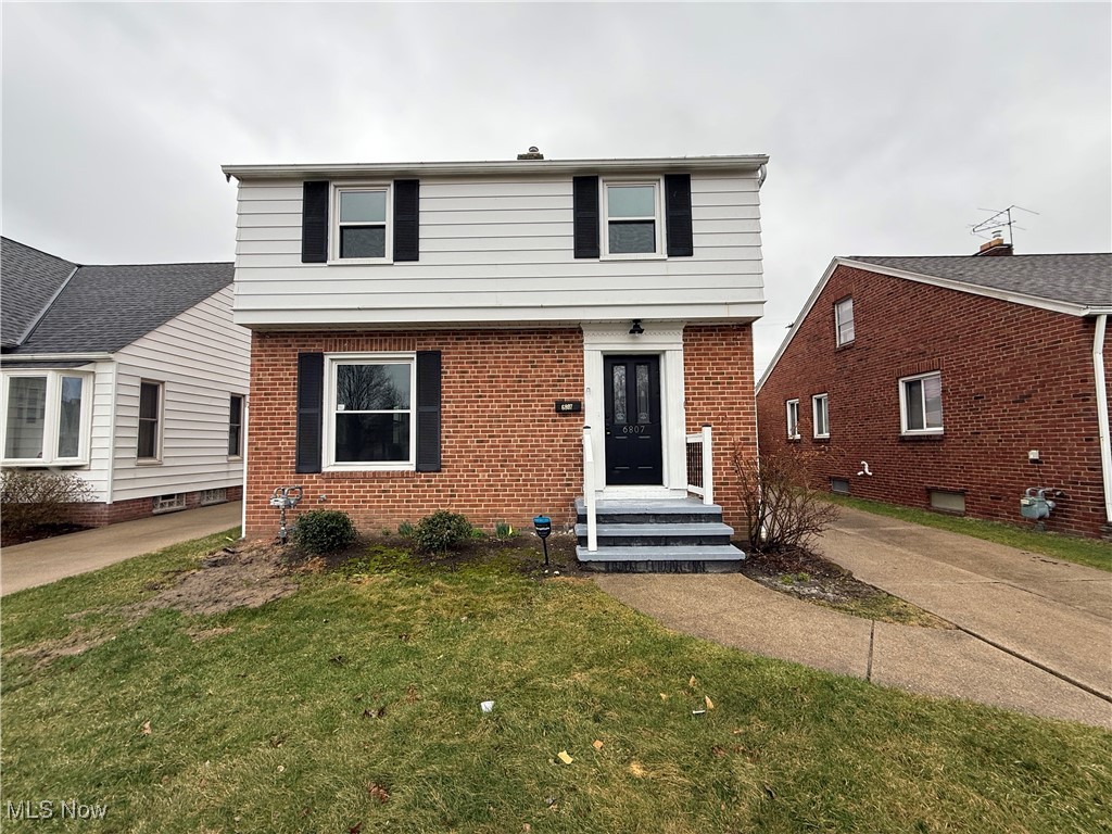 6807 Gerald Avenue Parma, OH 44129 - Photo 2 of 25 Colonial-style house featuring brick siding and a front lawn