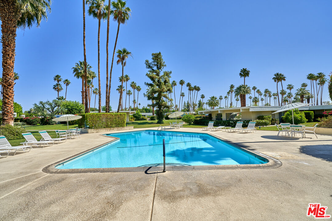1855 E. Ramon Road, Unit 19 Palm Springs, CA 92264 - Photo 41 of 42 a view of a swimming pool and a chair