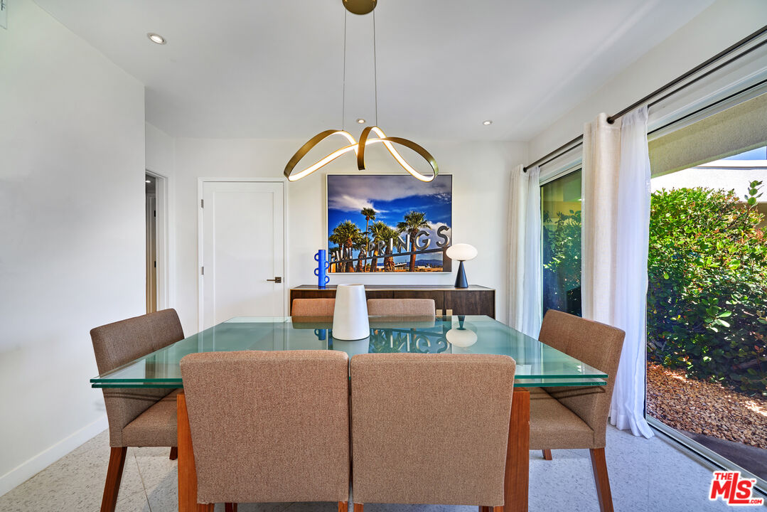 1855 E. Ramon Road, Unit 19 Palm Springs, CA 92264 - Photo 8 of 42 a view of a dining room with furniture window and wooden floor