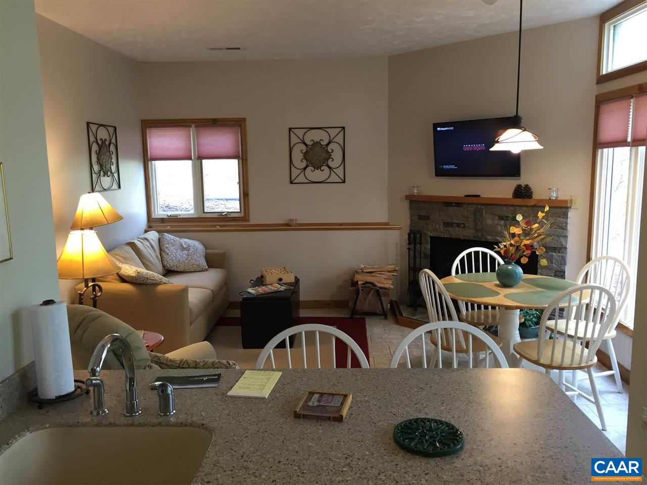 452 Three Ridges, Unit 452 Roseland, VA 22967 - Photo 6 of 28 a kitchen with a table chairs and a living room