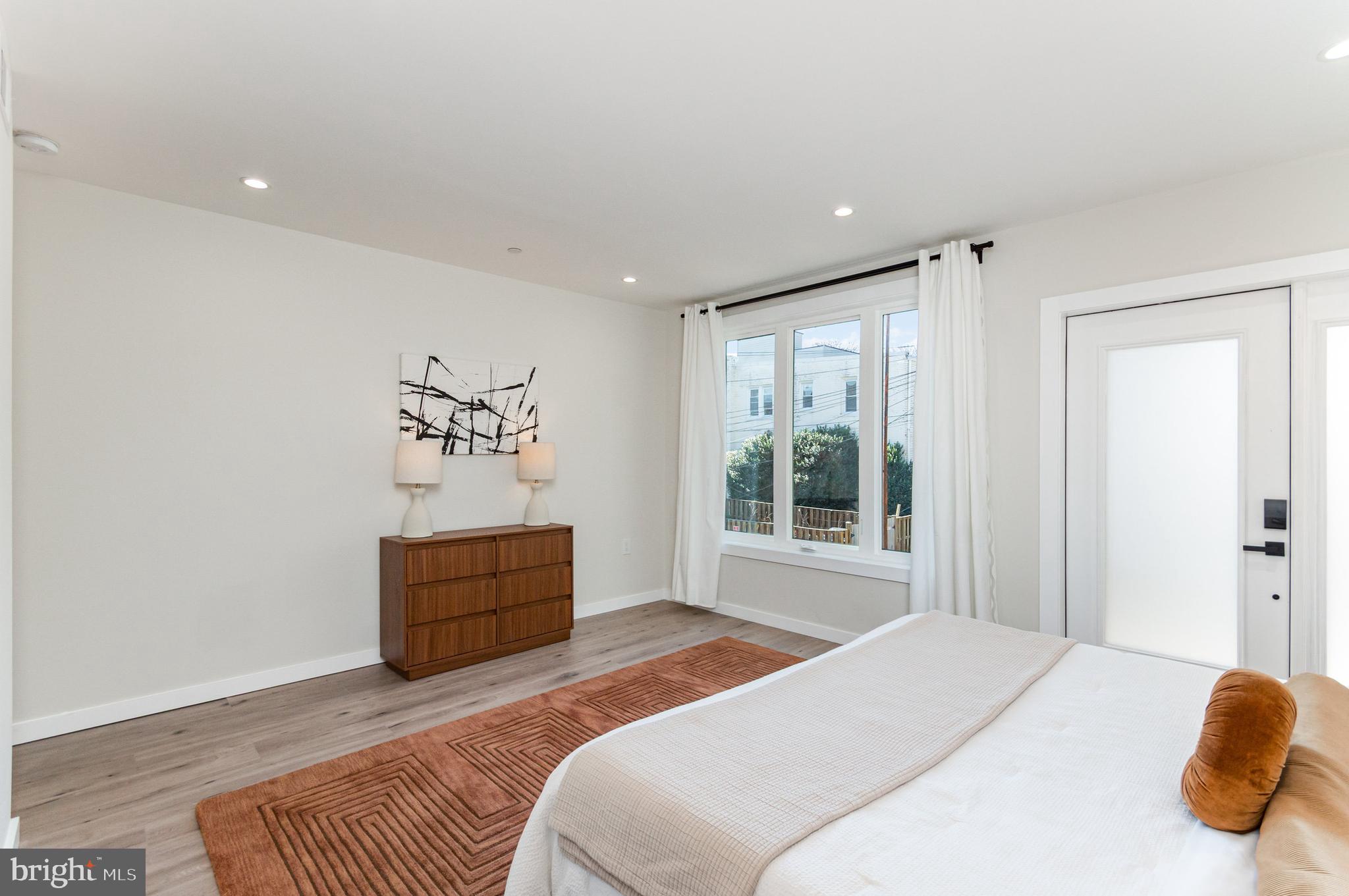 2116 4th Street Northeast, Unit B Washington, DC 20002 - Photo 13 of 28 a bedroom with a bed and a window