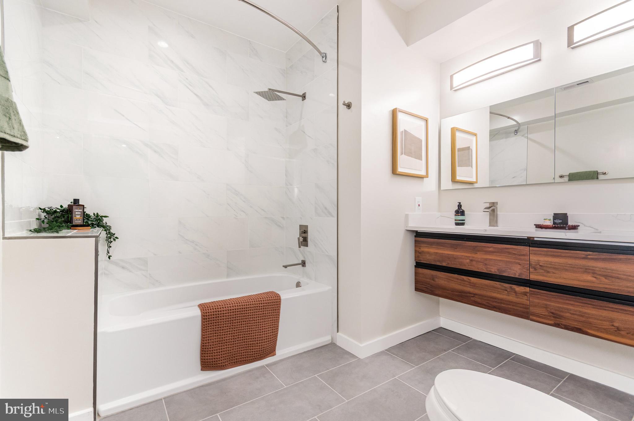 2116 4th Street Northeast, Unit B Washington, DC 20002 - Photo 14 of 28 a bathroom with a tub and a sink