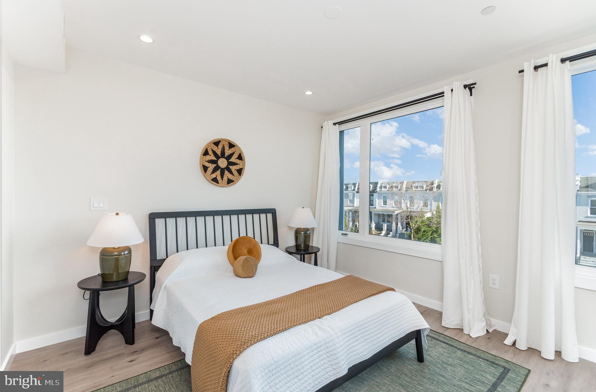 2116 4th Street Northeast, Unit B Washington, DC 20002 - Photo 16 of 28 a bed sitting in a bedroom next to a window