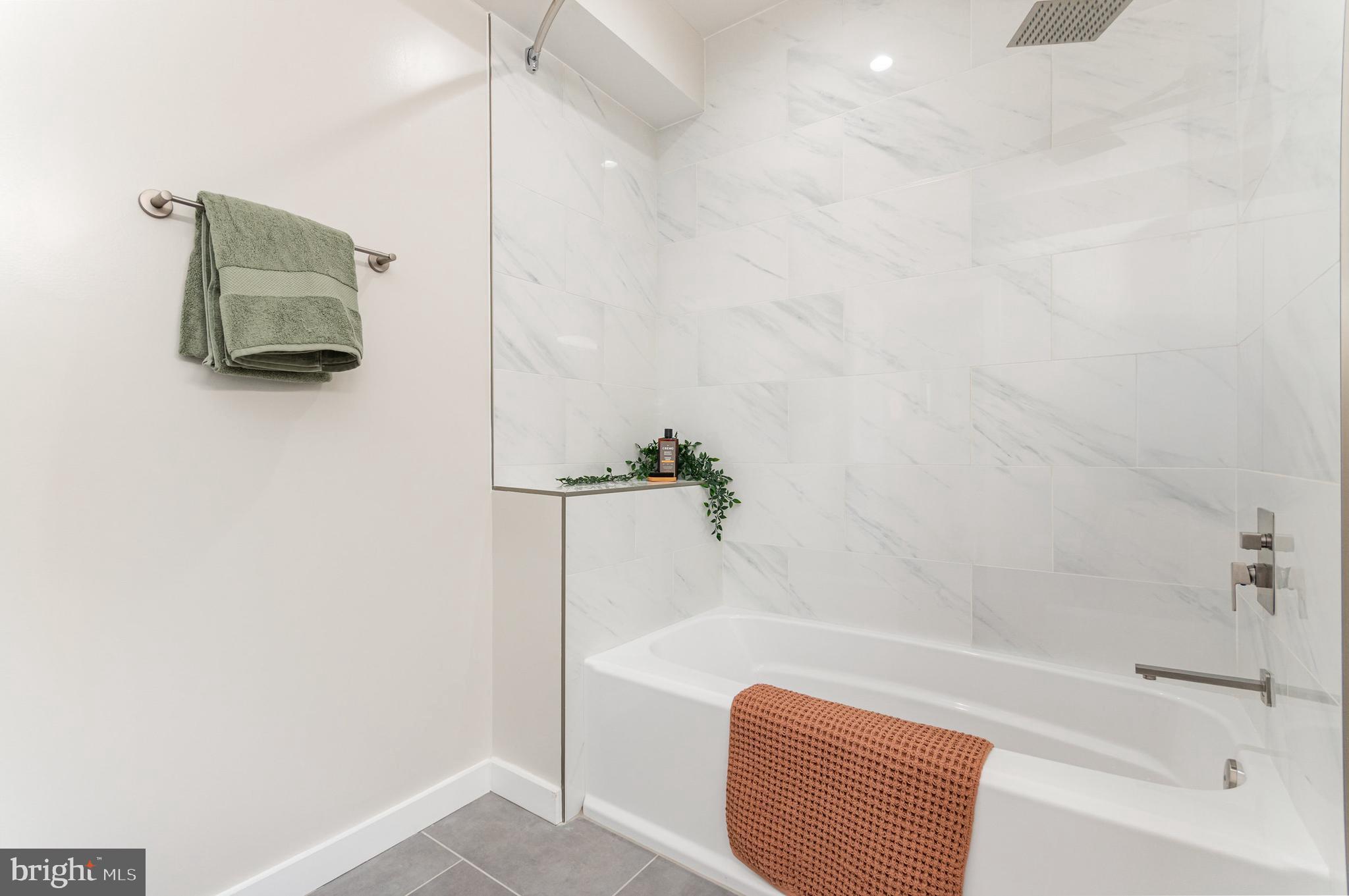 2116 4th Street Northeast, Unit B Washington, DC 20002 - Photo 19 of 28 a bathroom with a bathtub and a shower