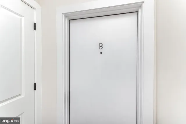 a living room with furniture kitchen view and a refrigerator