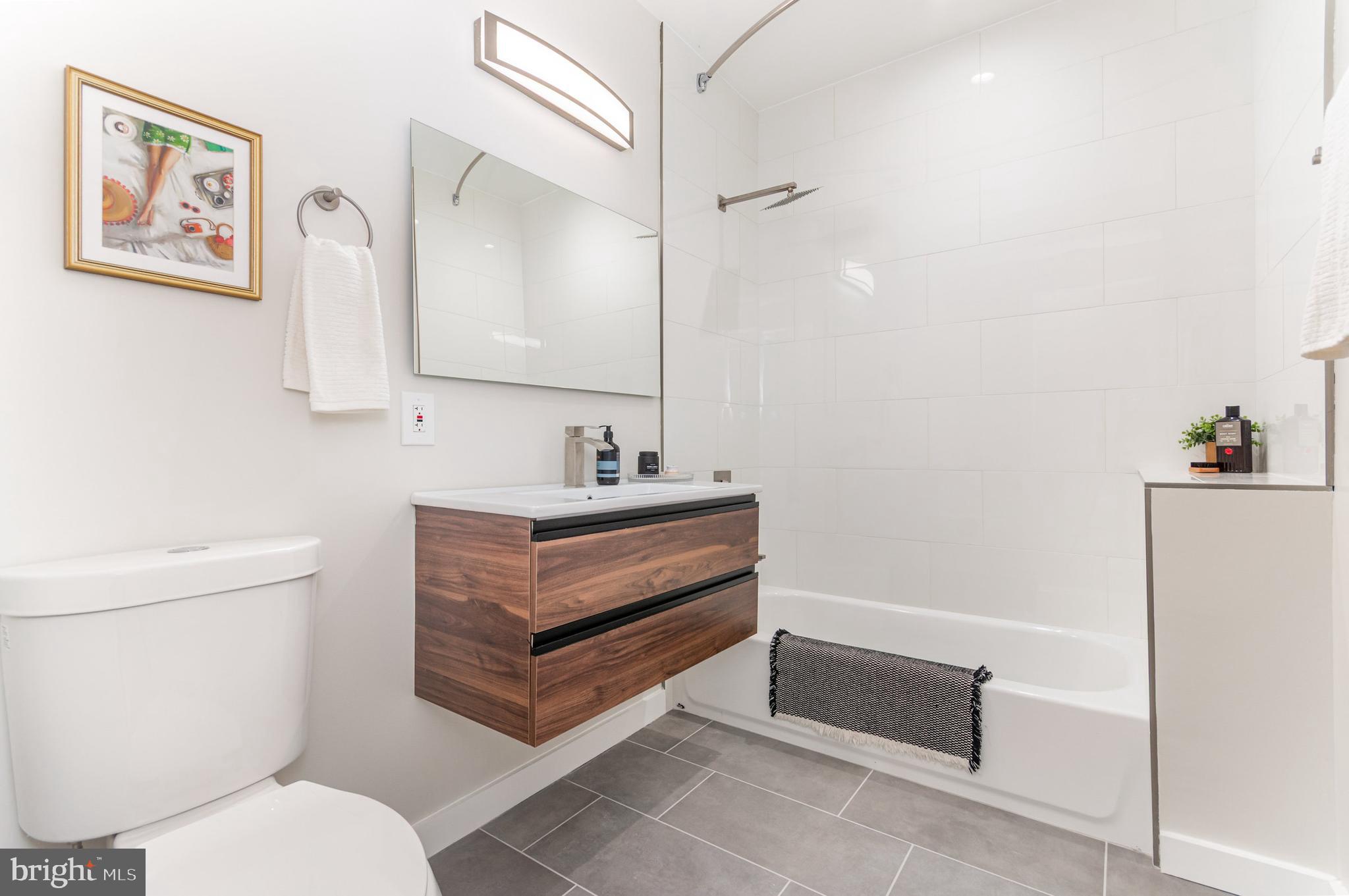2116 4th Street Northeast, Unit B Washington, DC 20002 - Photo 20 of 28 a bathroom with a toilet sink and mirror
