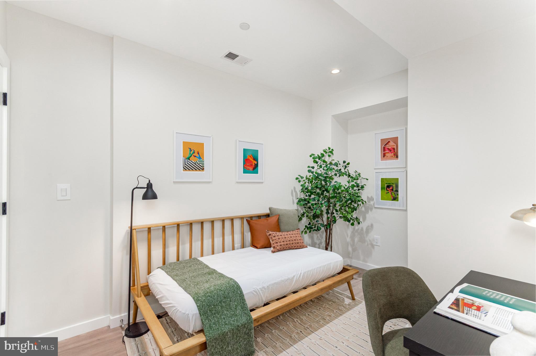 2116 4th Street Northeast, Unit B Washington, DC 20002 - Photo 21 of 28 a bedroom with a bed and a couch