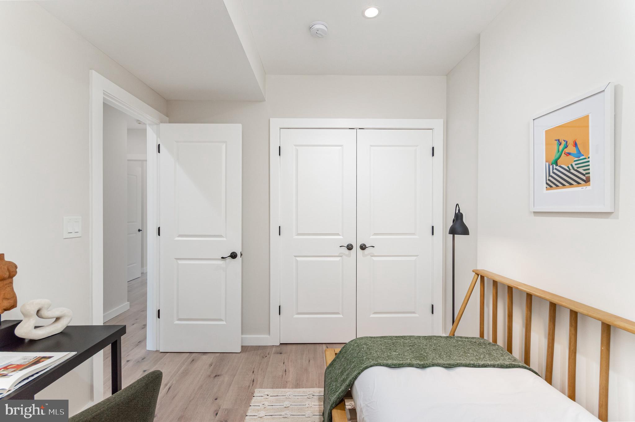 2116 4th Street Northeast, Unit B Washington, DC 20002 - Photo 23 of 28 a bedroom with a bed and wooden floor