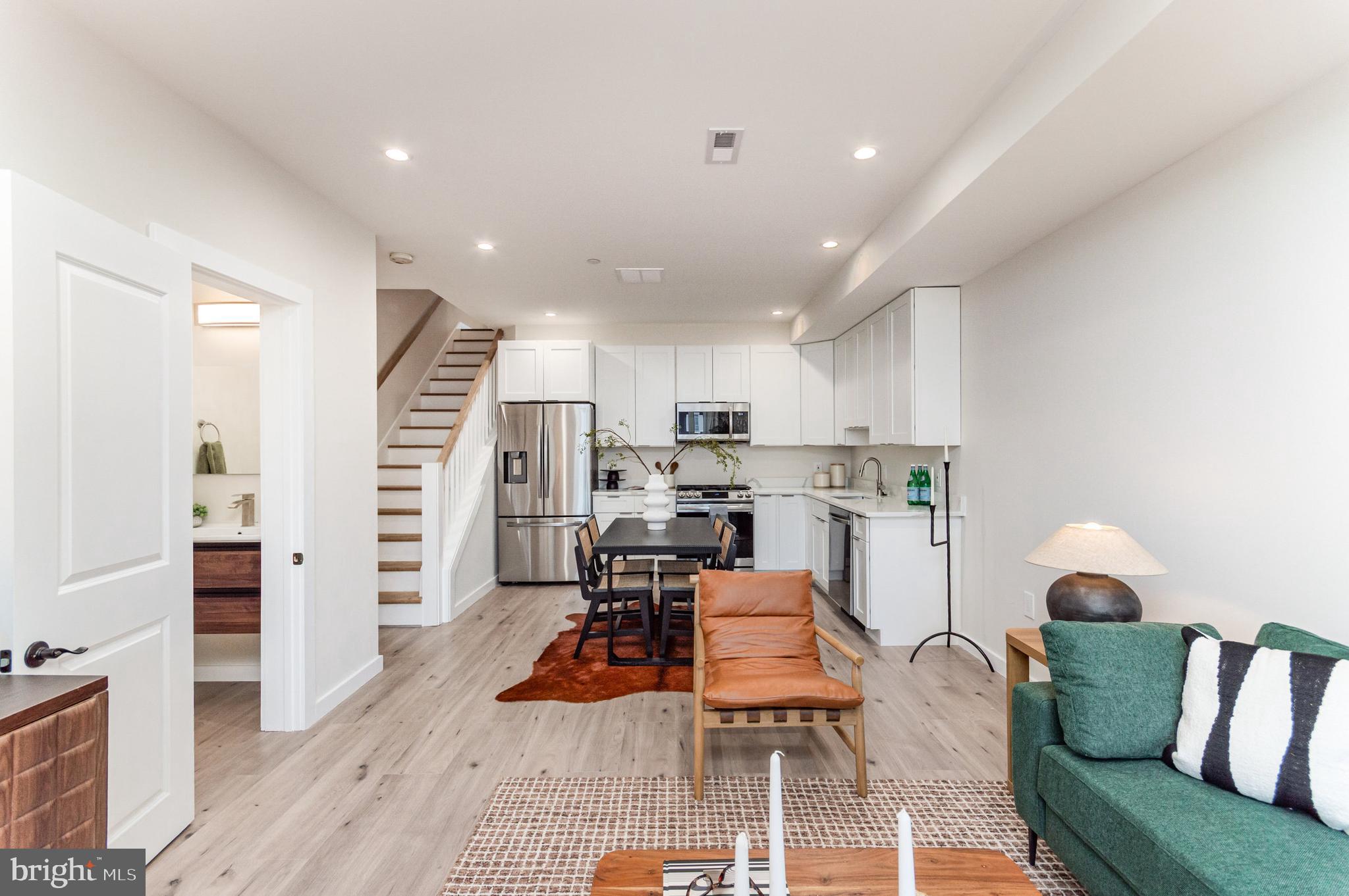 2116 4th Street Northeast, Unit B Washington, DC 20002 - Photo 5 of 28 a living room with furniture and kitchen view