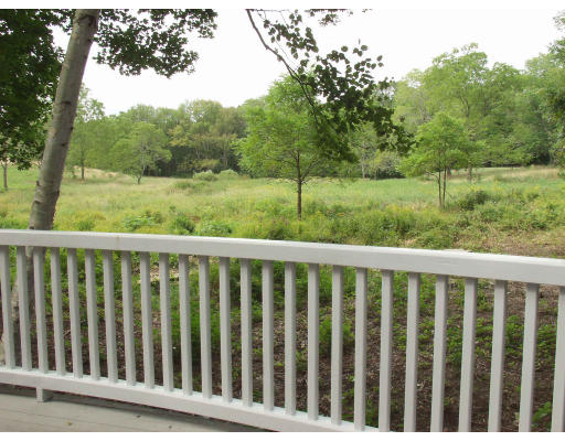 8 Sandy Pond Road Lincoln, MA 01773 - Photo 3 of 3 a balcony with wooden floor and fence