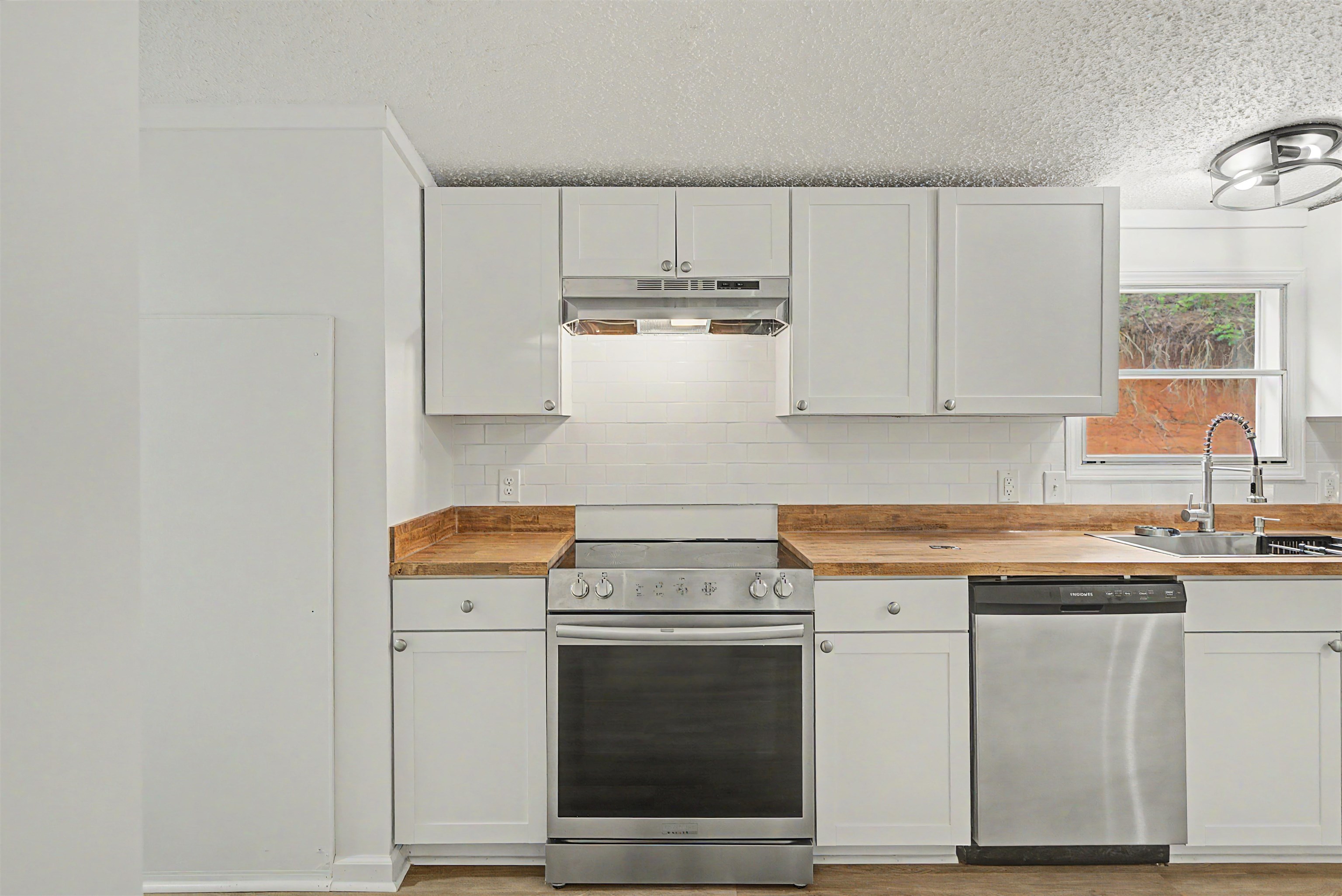 890 Burks Road Savannah, TN 38372 - Photo 12 of 40 a kitchen with granite countertop white cabinets and white appliances