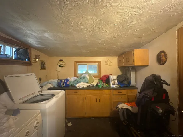 a living room with a couch and a stove next to a window