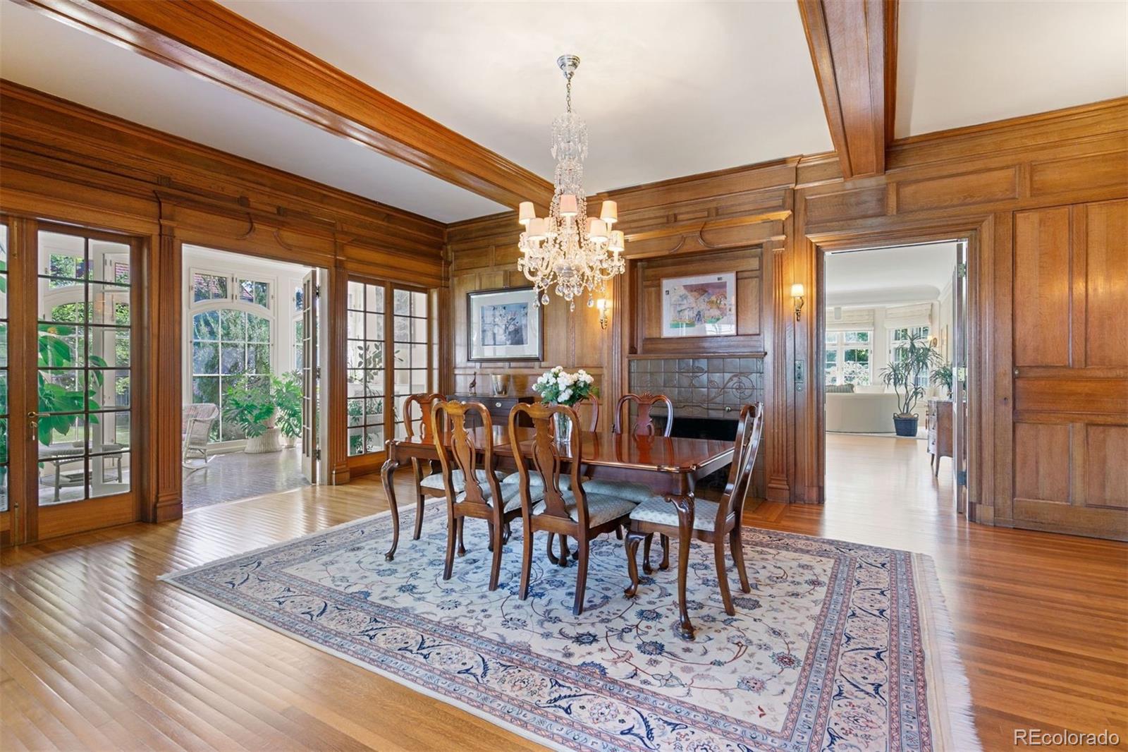 1415 North Cascade Avenue Colorado Springs, CO 80907 - Photo 17 of 48 a dining room with wooden floor a chandelier a wooden table and chairs