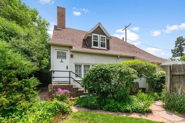 a dining room with furniture a chandelier and wooden floor