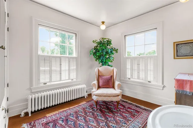 a view of a house with a yard and sitting area