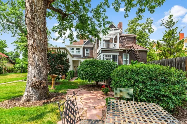 a living room with fireplace furniture and a large window