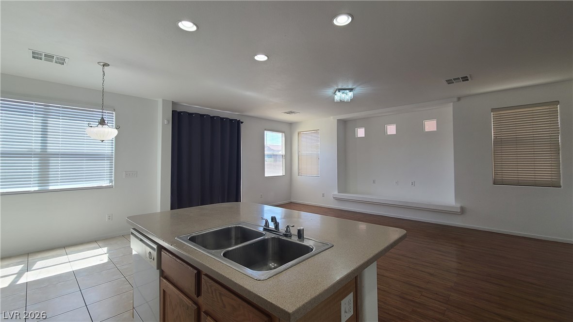 8944 Rutherford Grove Street Las Vegas, NV 89148 - Photo 10 of 35 A welcoming interior with bright illumination and wood-look flooring, perfect for daily living.