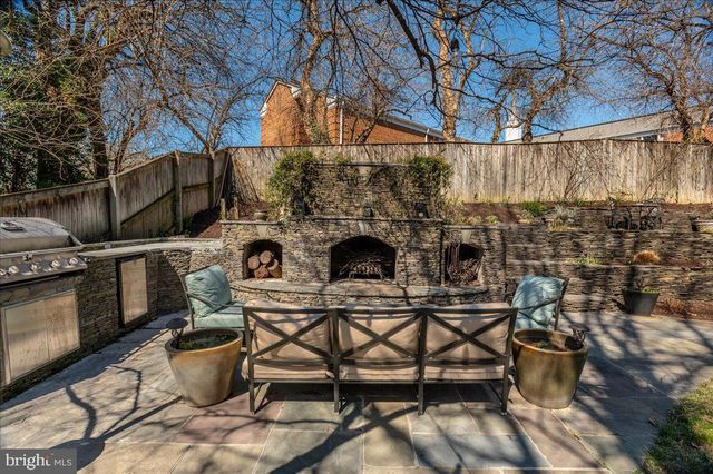 a view of backyard of house with seating area