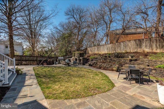a view of a kitchen counter space a sink wooden floor and living room view