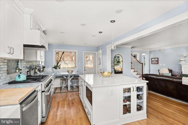 a view of a livingroom with furniture wooden floor and a window