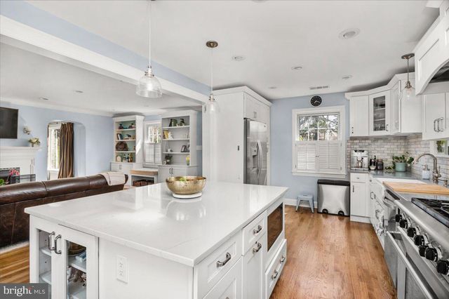 a bathroom with a granite countertop double vanity sink a mirror and a shower