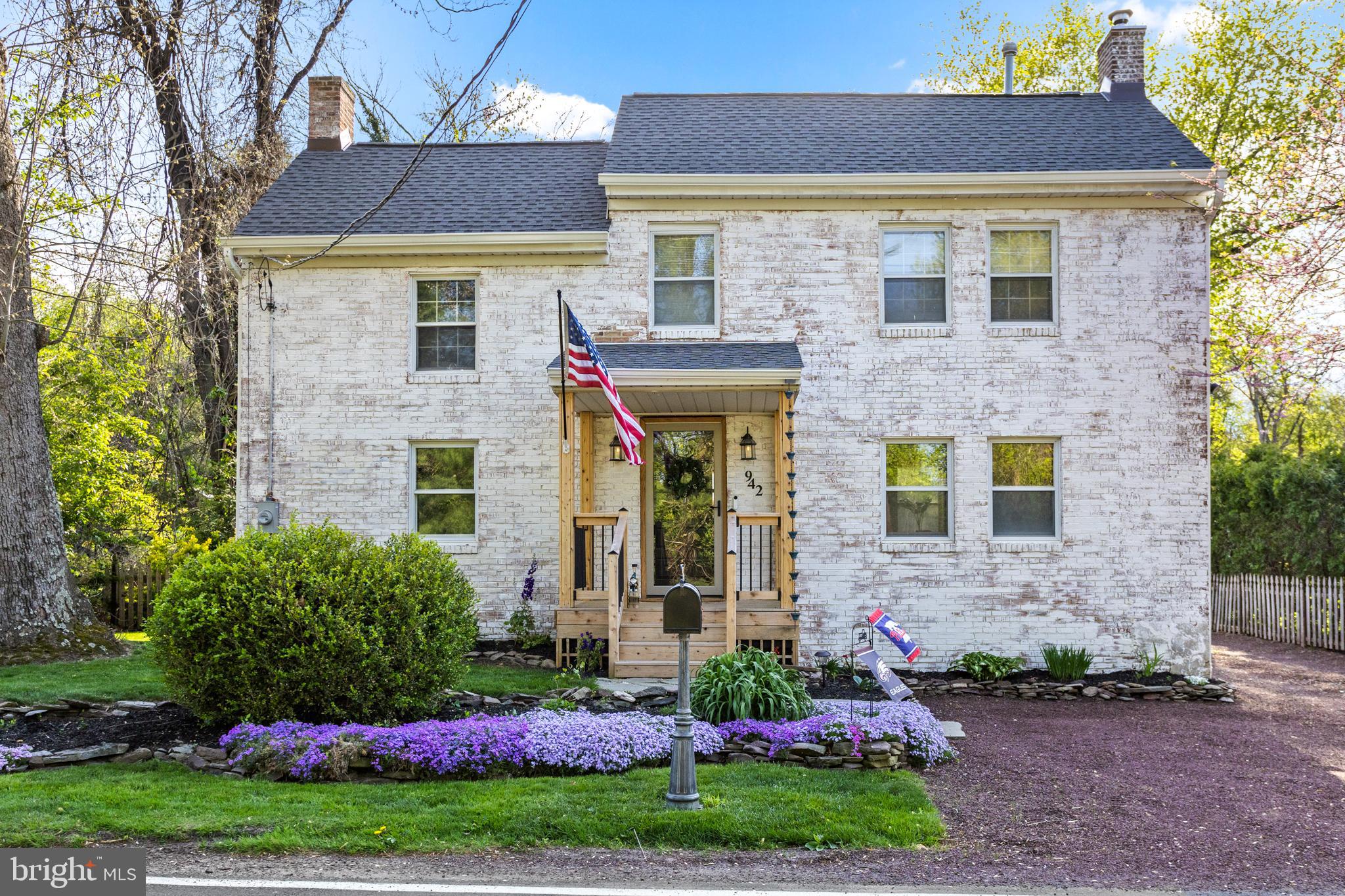 942 Province Line Road Allentown, NJ 08501 - Photo 1 of 50 a front view of a house with a garden and plants