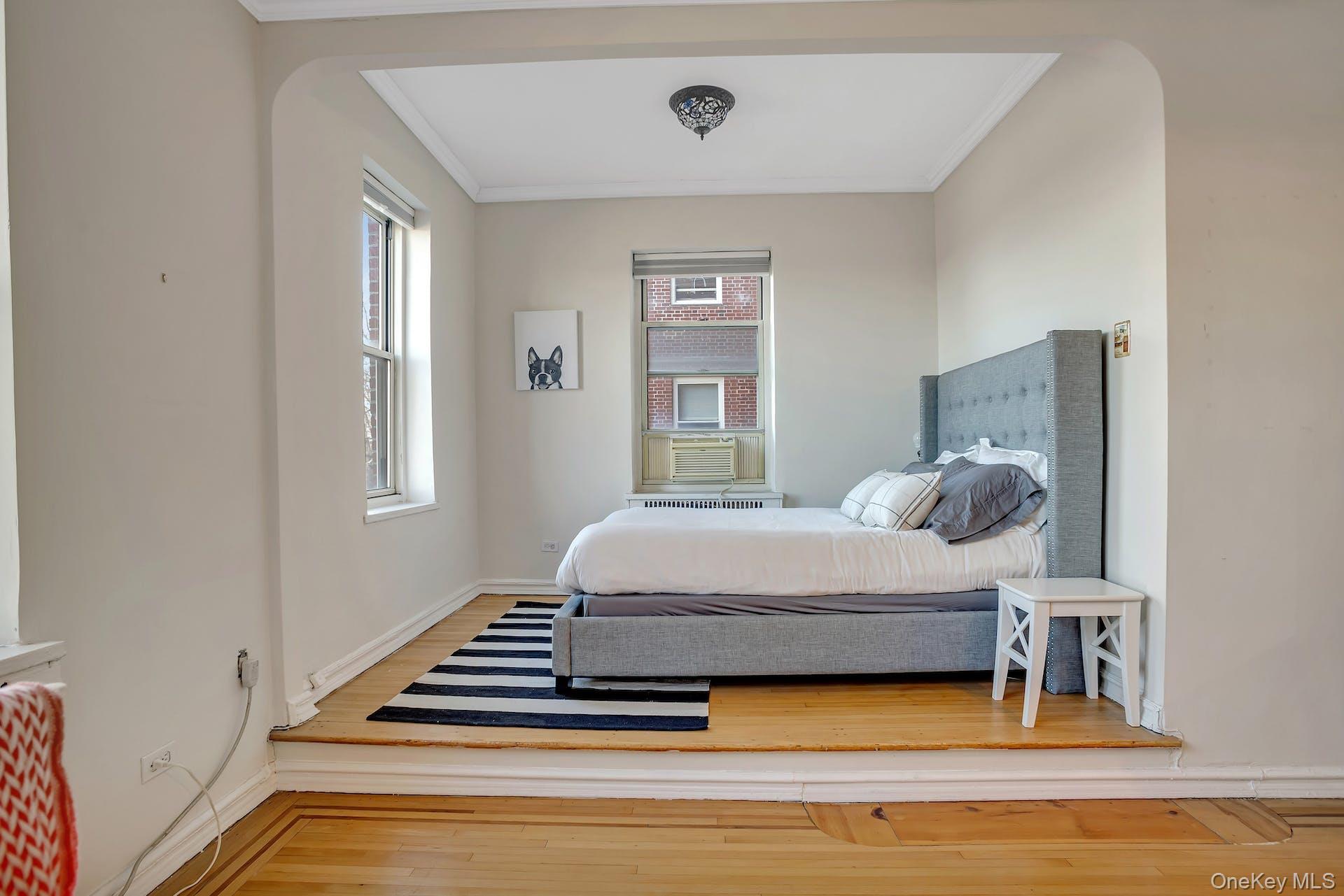 113-14 72nd Road, Unit 3D Queens, NY 11375 - Photo 11 of 22 a bedroom with a bed and window