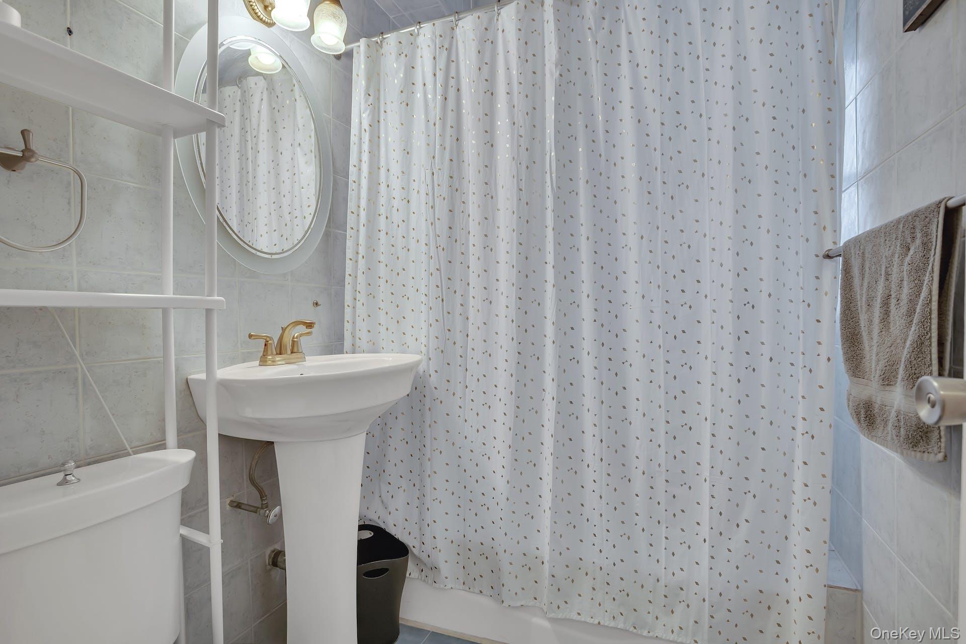 113-14 72nd Road, Unit 3D Queens, NY 11375 - Photo 15 of 22 a bathroom with a sink toilet and a mirror