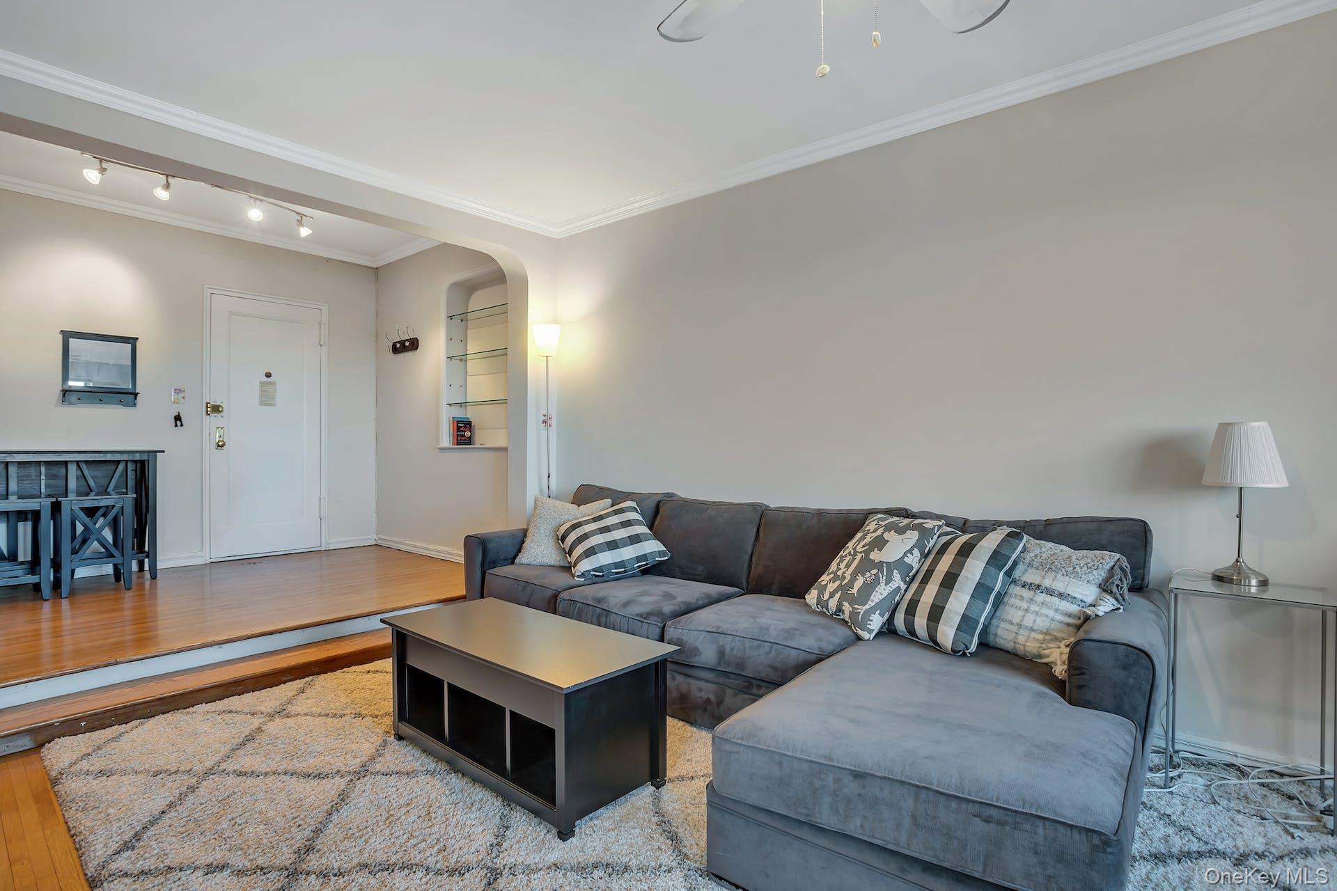 113-14 72nd Road, Unit 3D Queens, NY 11375 - Photo 4 of 22 a living room with furniture and a couch