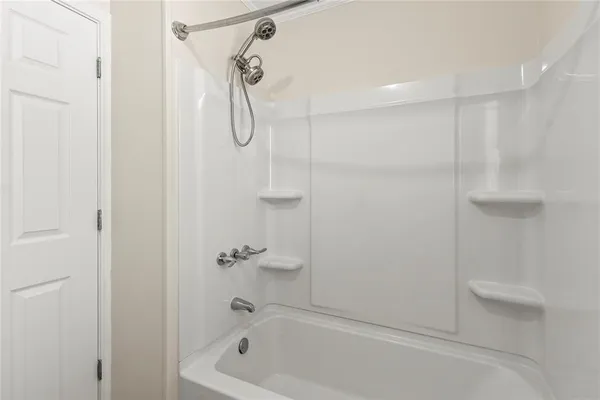 a bathroom with a bath tub with a shower