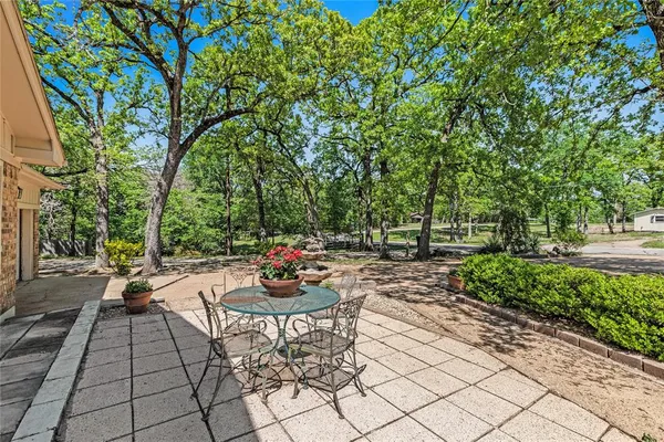 a view of a backyard with sitting area