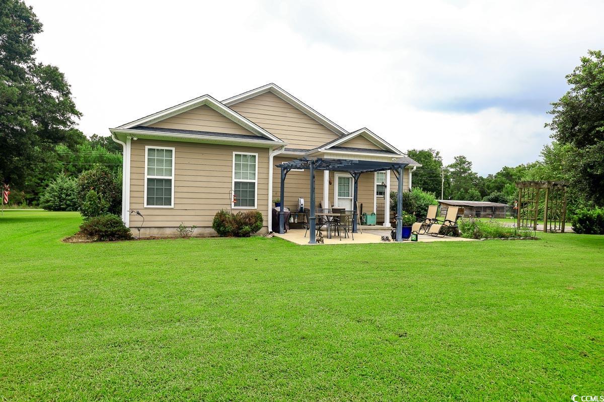 5900 Pope Martin Road Conway, SC 29527 - Photo 23 of 31 Rear view of house with a pergola, a patio, and a yard