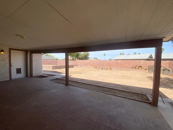 a view of an empty room with a floor to ceiling window