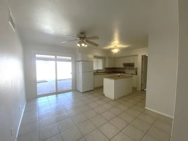 a kitchen with a sink a counter top space cabinets and stainless steel appliances