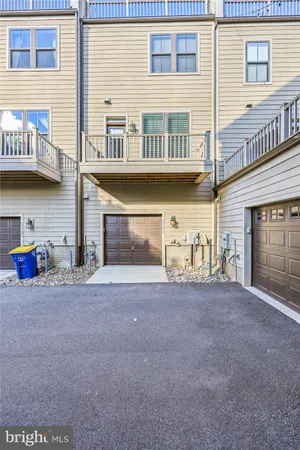 a view of a house with a patio and a yard