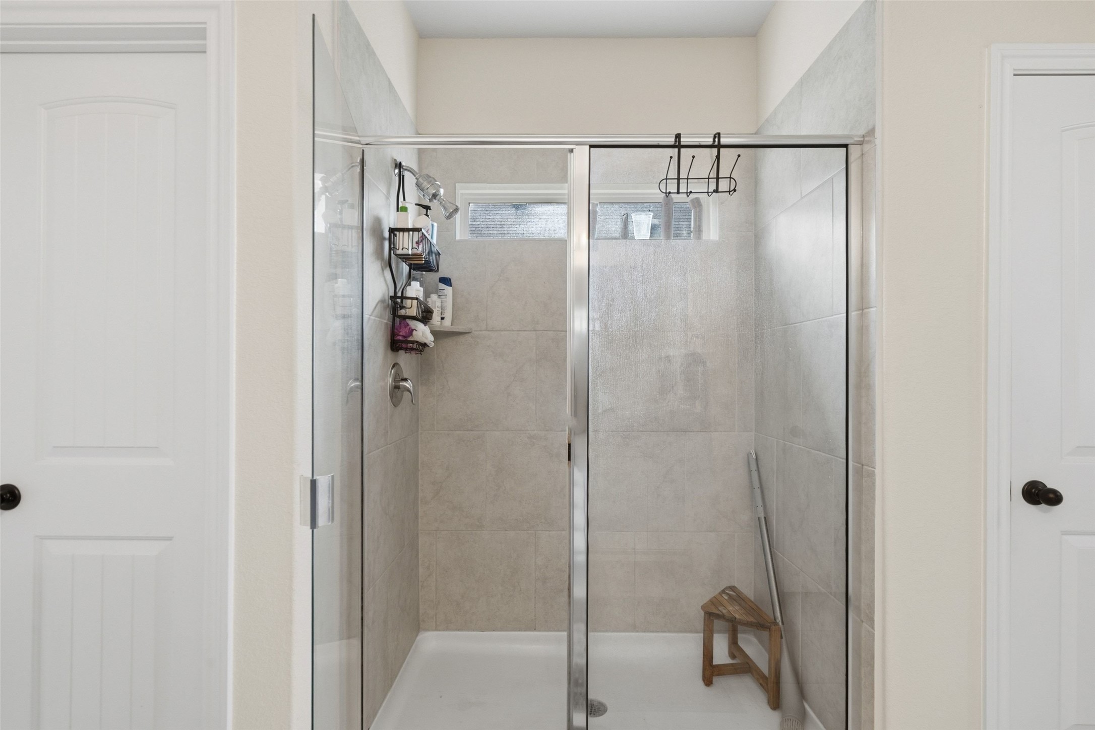 100 Panico Road Hutto, TX 78634 - Photo 24 of 28 A well-appointed shower stall features sleek tilework and clear glass enclosure.