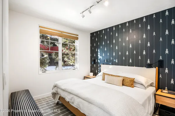 a bedroom with a bed and window